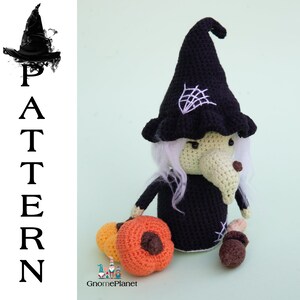 May include: Crocheted witch doll with a black hat, white hair, and a green face. The doll is holding a small orange pumpkin and is standing on a green background. The doll is wearing a black dress and has a spiderweb on her hat. The doll is part of a crochet pattern by GnomePlanet.