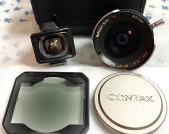 Lente Contax G Zeiss Hologon 16 mm f/8 T* Tapas de filtro central Caja de demostración en tienda