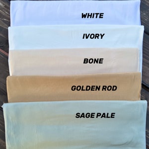 May include: Five fabric swatches in different shades of white, ivory, bone, golden rod, and sage pale. The swatches are labeled with their respective colors.