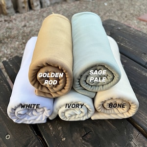 May include: Five rolled up fabric swatches in different colors. The swatches are labeled "White", "Golden Rod", "Sage Pale", "Ivory", and "Bone".