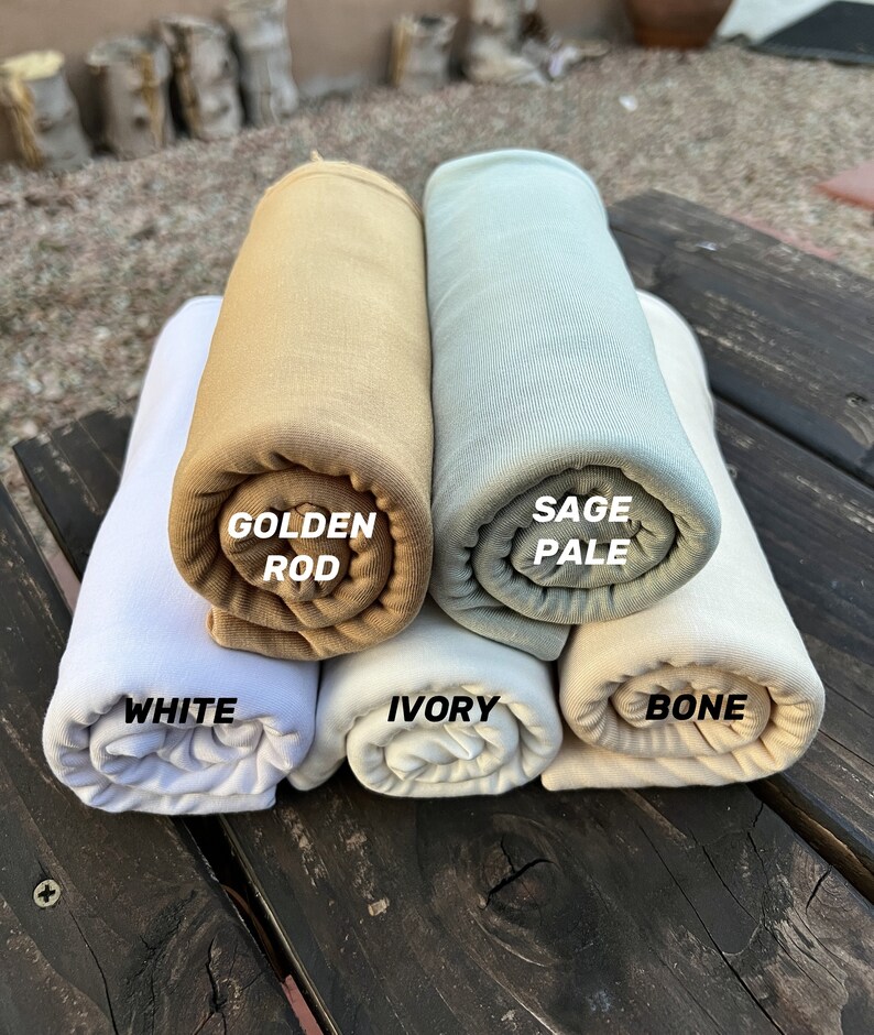 May include: Five rolled up fabric swatches in different colors. The swatches are labeled "White", "Golden Rod", "Sage Pale", "Ivory", and "Bone".