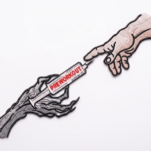 May include: Embroidered patch featuring a syringe labeled "PREWORKOUT" being touched by two hands. One hand is a light skin tone, the other is a dark gray skeletal hand. The patch is on a white background.