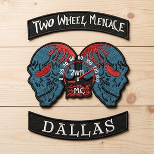May include: Embroidered patches with a motorcycle theme. The top patch reads "TWO WHEEL MENACE" in white script on a black background. Below is a patch with two blue skull-like figures with red accents and a speedometer. The bottom patch reads "DALLAS".