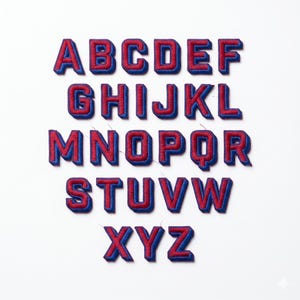 May include: Embroidered alphabet letters in red with blue edging, displayed on a white backdrop. The letters are in a bold, block style, and include the full alphabet from A to Z. The stitching detail is visible.