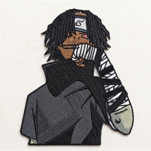 May include: Embroidered patch featuring a stylized anime character with black dreadlocks, a headband with a symbol, and a black and white striped bandage on the arm. The character is wearing a black jacket. The patch is on a white background.