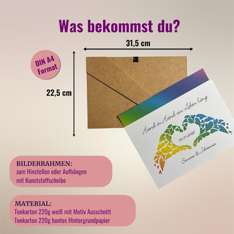 May include: A white card with a rainbow heart design and the text "Hand in Hand ein Leben lang" (Hand in Hand a lifetime) and "06.01.2028" and "Simone & Johannes". The card is 31.5 cm wide and 22.5 cm tall. It comes with a brown envelope and a picture frame.
