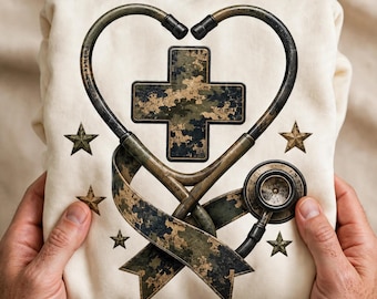 May include: A cream-colored sweatshirt featuring a graphic print of a stethoscope shaped into a heart. Inside the heart is a camouflage-patterned medical cross and a ribbon. Five camouflage-patterned stars are arranged around the central design.