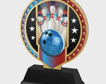 May include: A bowling trophy with a black base and a circular top. The top features a blue bowling ball and white bowling pins with red stripes, set against a patriotic red, white, and blue background. Gold accents and stars complete the design.