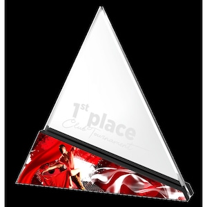 May include: A clear glass triangle trophy with a black base. The trophy has a red and white design with a couple dancing on it. The text "1st place Club Tournament" is printed on the trophy.