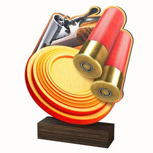 May include: A wooden trophy featuring a clay pigeon, two shotgun shells, and a shotgun. The trophy is mounted on a dark wood base.