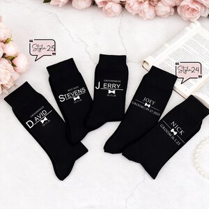 May include: Five black socks featuring white printed text and bow tie graphics. The socks are personalized with names such as David, Stevens, Jerry, Joey, and Nick, along with titles like Groomsman, Best Man, or Groom and specific calendar dates.