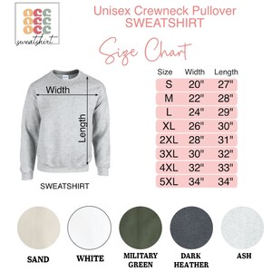 May include: A light grey unisex crewneck sweatshirt with a size chart. The chart shows measurements from size small (51 cm width, 69 cm length) to 5XL (86 cm width, 86 cm length). Available colours are sand, white, military green, dark heather, and ash.
