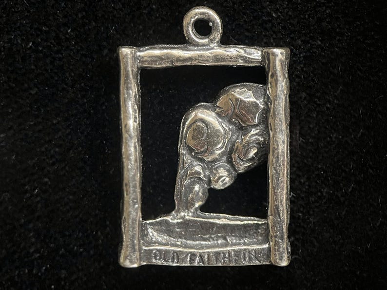 May include: Silver charm with a detailed image of a bear inside a square frame. The charm has the words "Old Faithful" inscribed on the bottom.