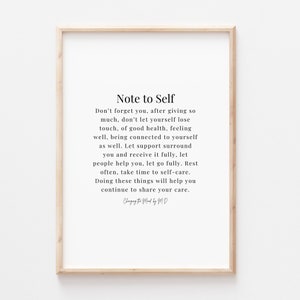 May include: A framed print featuring the text "Note to Self" in a minimalist design. The black text is set against a white backdrop, enclosed within a light wood frame. The message promotes self-care and well-being.