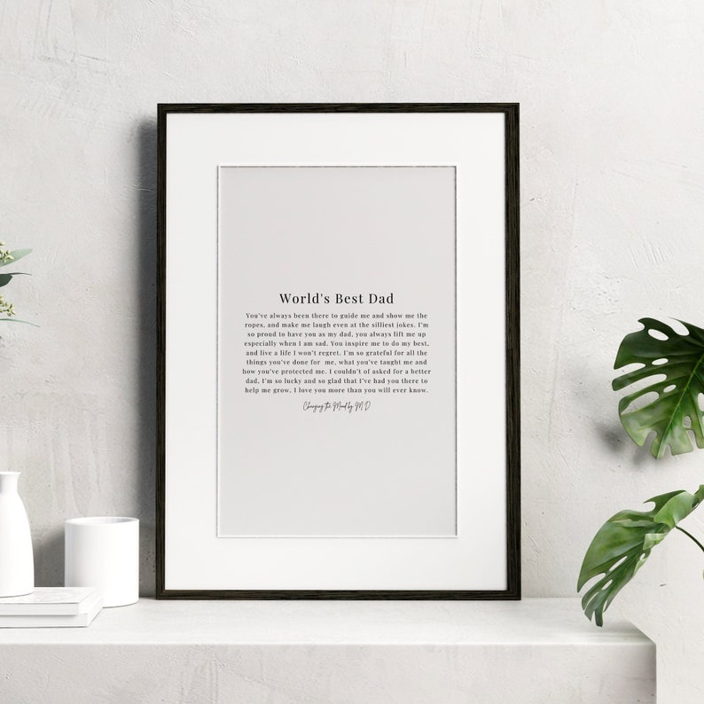 May include: A framed print with a white background and black text that reads "World's Best Dad". The text is a poem about a father's love and guidance.