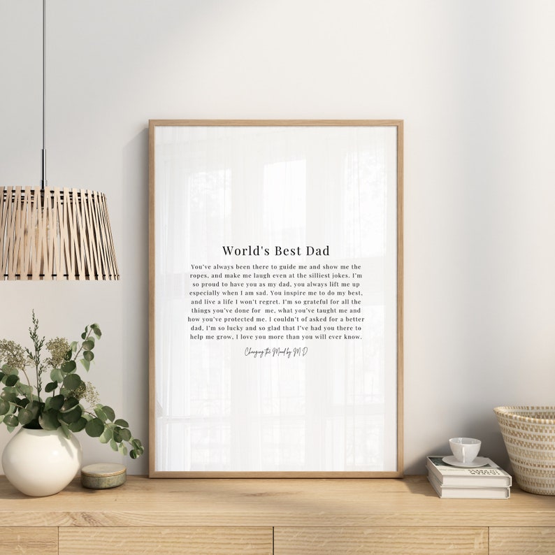 May include: A white printable poster with a black and white text design that reads "World's Best Dad". The text is a poem about a father's love and guidance. The poster is framed in a simple black frame.