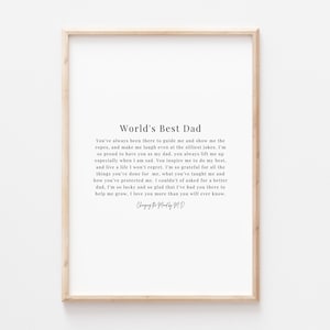 May include: A framed print with a white background and black text. The text reads "World's Best Dad" and includes a poem about a father's love and guidance.