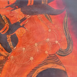 May include: A detailed painting featuring a vibrant orange and red background with a central figure adorned in intricate gold jewelry. The figure wears a multi-layered beaded waist chain and a necklace composed of small, carved face-like charms.