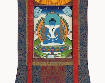 May include: A vertical wall hanging scroll featuring a central painting of a blue deity in a meditative pose on a lotus base. The artwork is framed by a yellow silk top, two long red fabric streamers, and a blue patterned border with wooden rods.