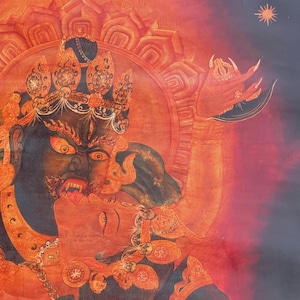 May include: A detailed painting featuring a dark blue deity with a fierce expression, wearing an ornate crown and holding a curved blade. The deity embraces a red figure against a vibrant orange and red background with a small sun symbol.