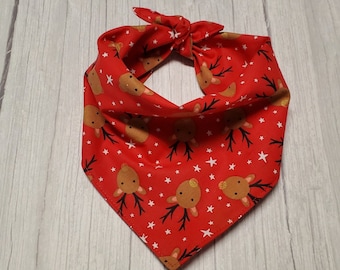 May include: Red bandana with a white star and reindeer pattern.