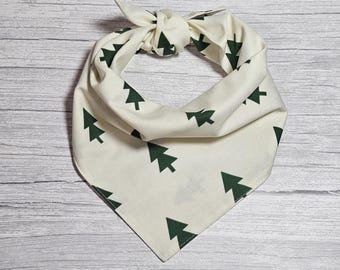 May include: A white bandana with a green tree pattern. The bandana is tied in a knot at the top.
