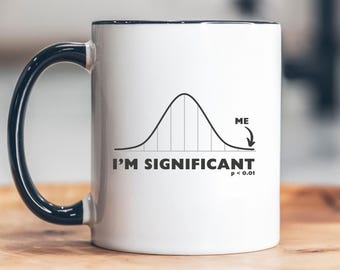 May include: White ceramic mug with a black rim and handle. The mug features a black and white illustration of a bell curve with the text "I'm Significant p < 0.01" and "ME" with an arrow pointing to the right tail of the curve.