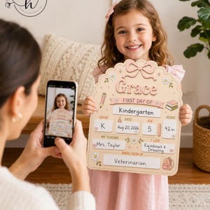 May include: A light beige, scalloped-edge wooden sign for the first day of school. It features the name Grace, grade K, date Aug 20, 2026, age 5, height 42 in, teacher Mrs. Taylor, interests in rainbows and drawing, and the goal of being a veterinarian.