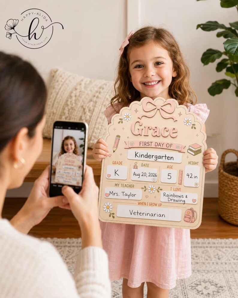 May include: A light beige, scalloped-edge wooden sign for the first day of school. It features the name Grace, grade K, date Aug 20, 2026, age 5, height 42 in, teacher Mrs. Taylor, interests in rainbows and drawing, and the goal of being a veterinarian.