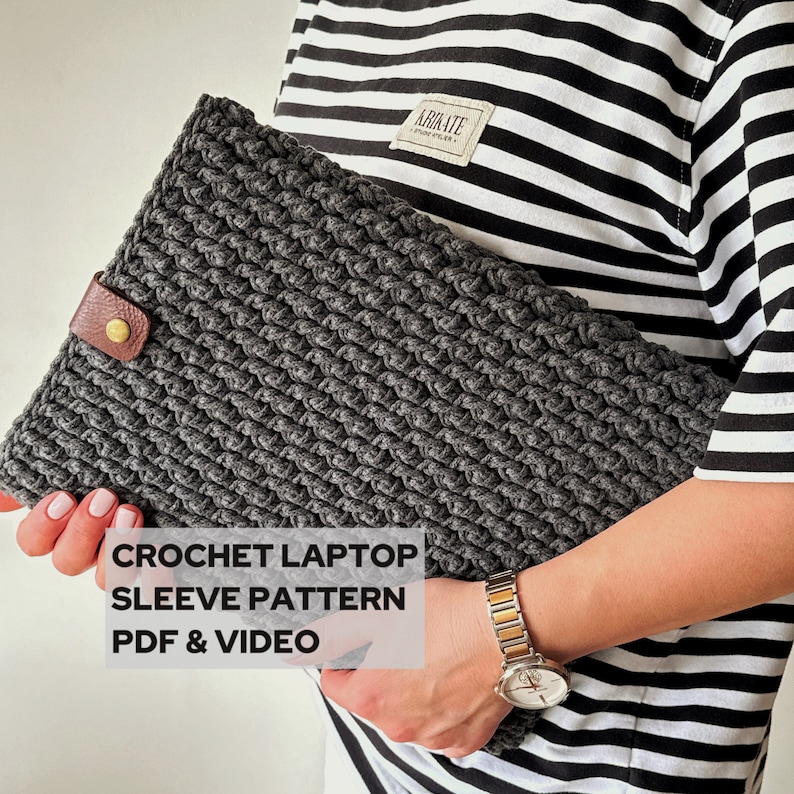 May include: A gray crocheted laptop sleeve with a brown leather strap and a gold metal buckle. The text "CROCHET LAPTOP SLEEVE PATTERN PDF & VIDEO" is printed on the sleeve.