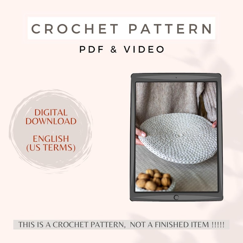 May include: A digital download crochet pattern for a round, white crocheted coaster. The pattern is available in English (US terms) and includes a PDF and video tutorial. The image shows a finished coaster on a table with walnuts.