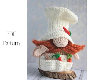 May include: A crocheted chef gnome with a white hat, red beard, and a beige nose. The gnome wears a white apron with a mushroom and vegetables. The text "PDF Pattern" is on the left.