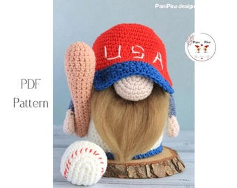 May include: A handmade crochet gnome wearing a red hat with "USA" in white letters and a blue brim. The gnome holds a baseball bat and sits on a wooden base, with a baseball nearby. The image also includes the text "PDF Pattern".