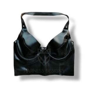 May include: A black halter top with a shiny finish and a 'HARNESS DESIGNS' logo on the front.