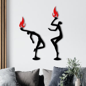 May include: Two black silhouette figures with red flames on top, one figure is bending over and the other is standing straight up, both figures are on a white background.