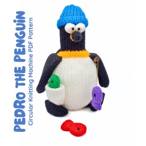 May include: A knitted penguin toy with a blue hat, black and white body, and orange beak. The penguin has a pocket with a green ball and a fishing line with a purple fish. The text "PEDRO THE PENGUIN" is on the left.