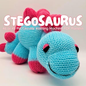 Light blue knitted Stegosaurus with pink spikes and feet. With the title, Stegosaurs, 46 or 48 Pin Circular Knitting Machine PDF Pattern.