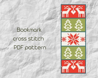 May include: A cross stitch bookmark pattern featuring a red and white snowflake design, green trees, and white reindeer with red antlers. The pattern is in a PDF format.