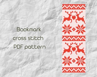 May include: Red and white cross stitch bookmark pattern featuring two reindeer and snowflakes. The pattern is on a white background and is ready to be stitched.