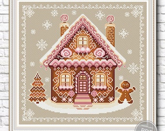 May include: A cross-stitch pattern of a gingerbread house with pink and white frosting, candy canes, and a gingerbread man standing in front of it. The house is surrounded by a snowy landscape with a small evergreen tree.