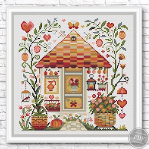 May include: Cross-stitch pattern of a charming cottage with a red and orange checkered roof, surrounded by floral elements, hearts, and a butterfly. The design includes a birdcage, flowers in baskets, and a small window.