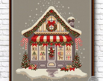 May include: A cross-stitch pattern of a festive Christmas shop with a red and white striped awning, decorated with garlands, candy canes, and a wreath. The shop windows are filled with gifts and toys. The shop is covered in snow and surrounded by snow-covered trees.