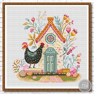 May include: Cross-stitch of a whimsical house with a black and white chicken. The house has an orange roof, a teal door, and is surrounded by flowers and Easter eggs. The artwork is framed in a brown wooden frame.