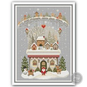 Gray variation of counted cross stitch design showing whimsical winter house, primitive style gnome, red hearts, lanterns, and holiday trees. Perfect for fans of rustic embroidery and cozy Christmas patterns. Digital download PDF.