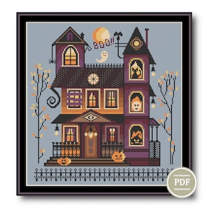 May include: Cross stitch pattern of a spooky, multi-coloured, three-storey house with a fence, trees, and pumpkins. The house has a clock, a ghost, and a cat in the windows. The text "Boo!" is above the house.