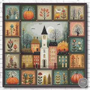 May include: A cross-stitch pattern featuring a central town scene with a tall white church tower surrounded by multi-colored houses, framed by twelve smaller square panels depicting autumn trees, orange pumpkins, and various floral motifs.