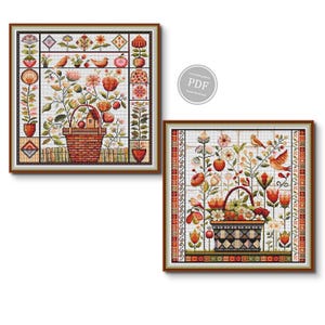 Op de afbeelding: Twee ingelijste kruissteekpatronen. Eén toont een mand met bloemen en fruit, vogels en een klein huis. De andere heeft een vergelijkbaar ontwerp met een mand met bloemen, vogels en decoratieve randen. Beide zijn in warme kleuren.