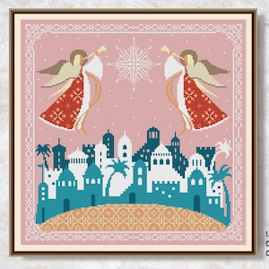 May include: Cross-stitch pattern featuring two angels with trumpets, a snowflake, and a cityscape in the background. The angels are wearing red robes with white accents and have golden halos. The cityscape is a mix of blue and white buildings with palm trees.