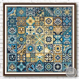 May include: A cross-stitch pattern featuring a colorful mosaic of blue, yellow, and gray tiles with geometric designs. The pattern is framed in a brown wood frame.