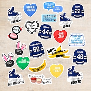 May include: A selection of vibrant stickers featuring hockey-themed designs and text. Includes hockey jerseys, ice skates, and heart shapes with names like "Graham" and "Logan." Also features a banana and the text "It's a house party. We need dippables."
